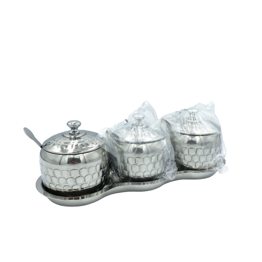 Silver three-jar condiment set with honeycomb design on a white background